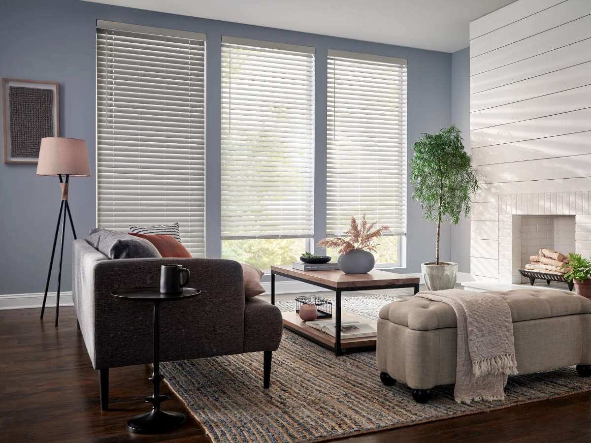 Alta Window Fashions faux wood blinds enhancing the cozy ambiance of a modern living room.